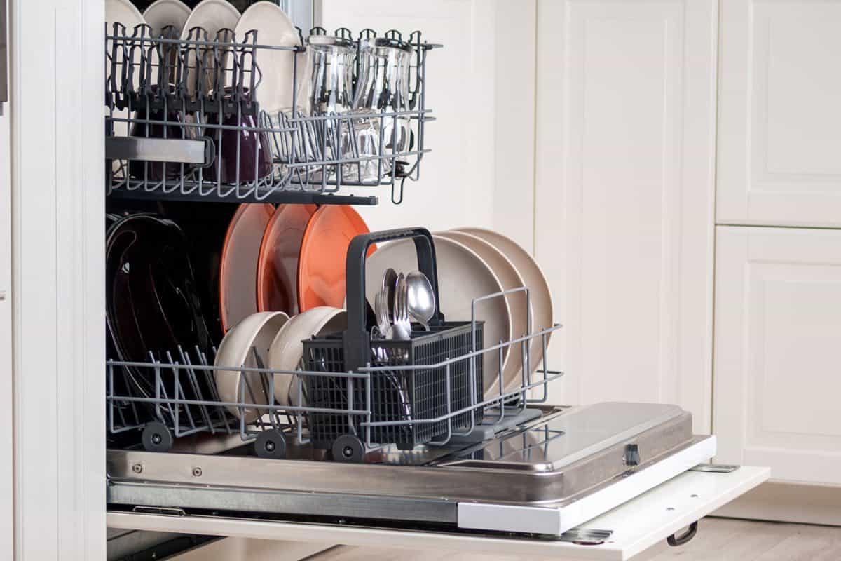 An opened dishwasher with newly cleaned plates