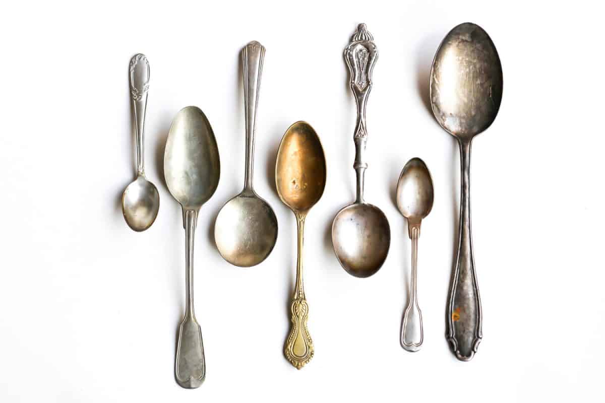 Antique silver spoons isolated on white background.