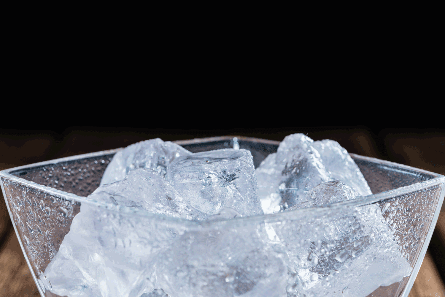Bowl with Ice Cubes in dark background
