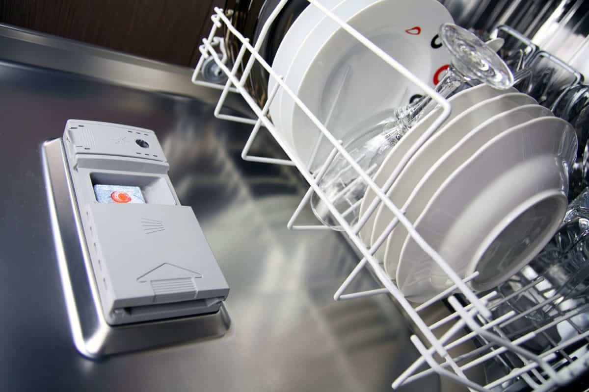 Close-up photo of a dishwasher with clean dishes inside