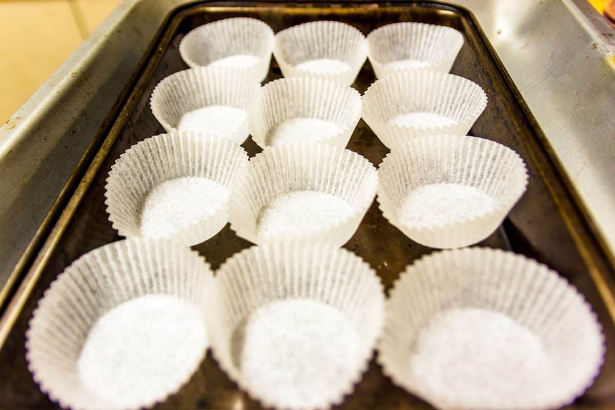 Empty paper muffin cups on baking tray