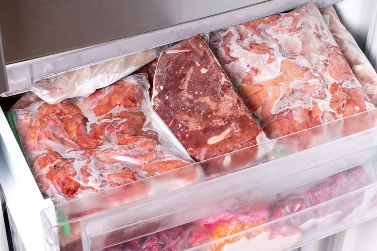 Freezer Filled with Meat and meat frozen products. Meat Frozen in Plastic Bags Food Reserve Stored for Food Preparation