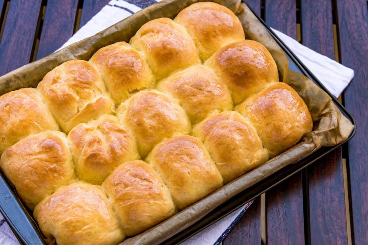 Fresh and homemade dinner rolls, buns in a baking sheet close-up image.