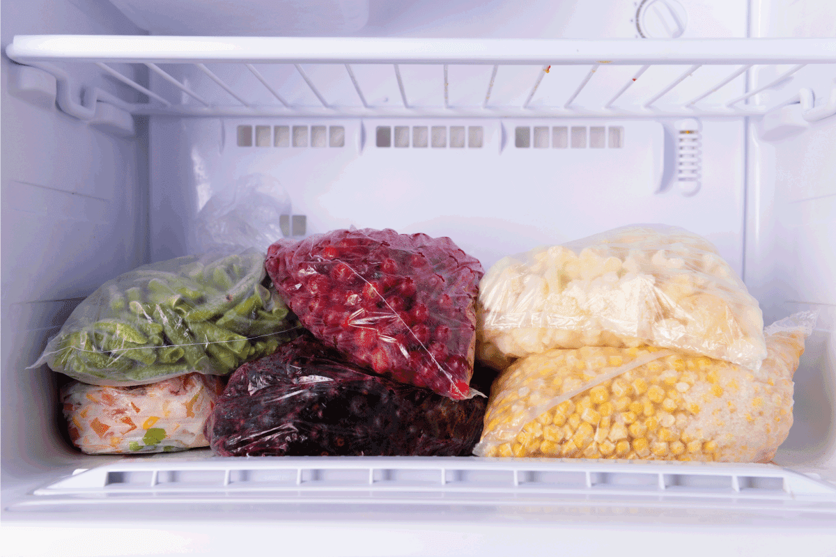Frozen berries and vegetables in bags in freezer. For How Long Can You Leave Freezer Door Open
