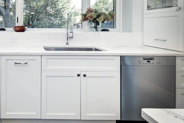 A modern kitchen sink with dishwasher and white cabinets, Should Dishwasher Be On The Left Or Right Of Sink?