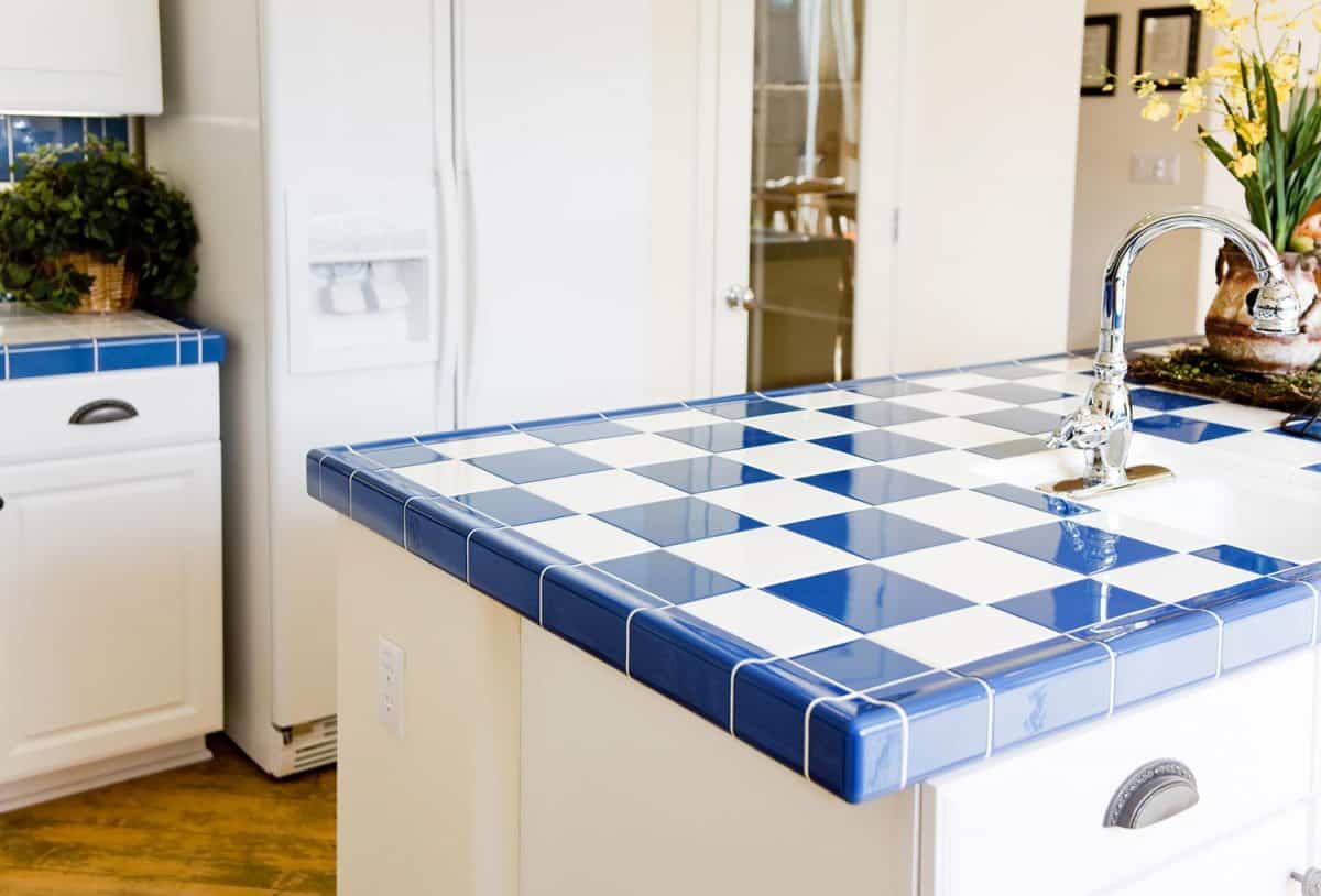 Modern kitchen interior with checkered white and blue tile
