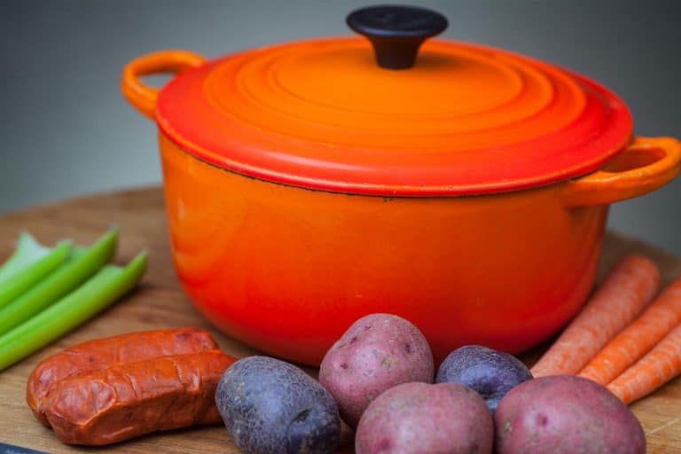 Orange Dutch oven with vegetables, Types, Sizes, And Brands Of Dutch Ovens You Should Know