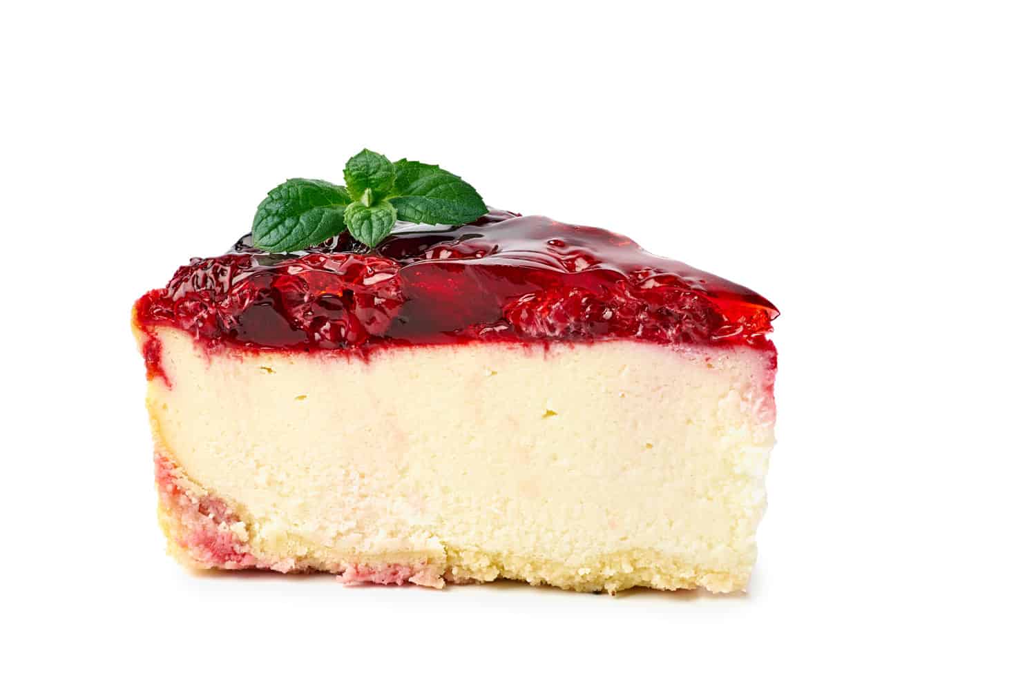 Piece of cheesecake with raspberries topping isolated on white.