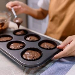 Process of cooking delicious homemade muffin and Halloween cupcake. Woman preparing and mixing ingredients for sweet food dessert in kitchen at home, Can Muffin Pans Go In The Dishwasher?