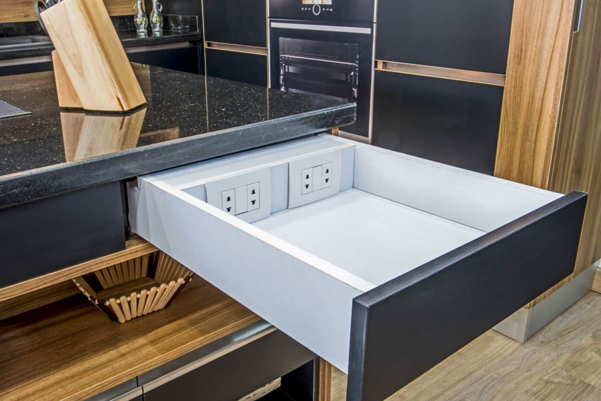 Rustic interior of a modern contemporary kitchen with a drawer attached with sockets