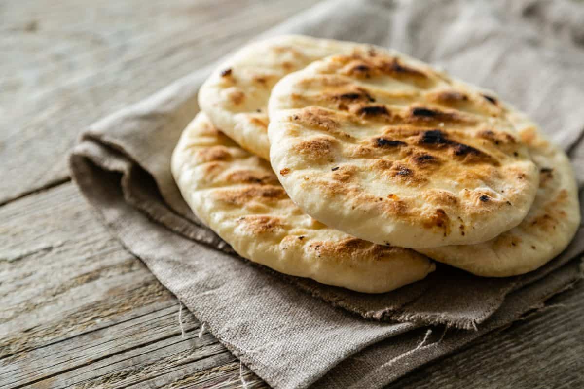 Traditional pita bread on rustic wood background