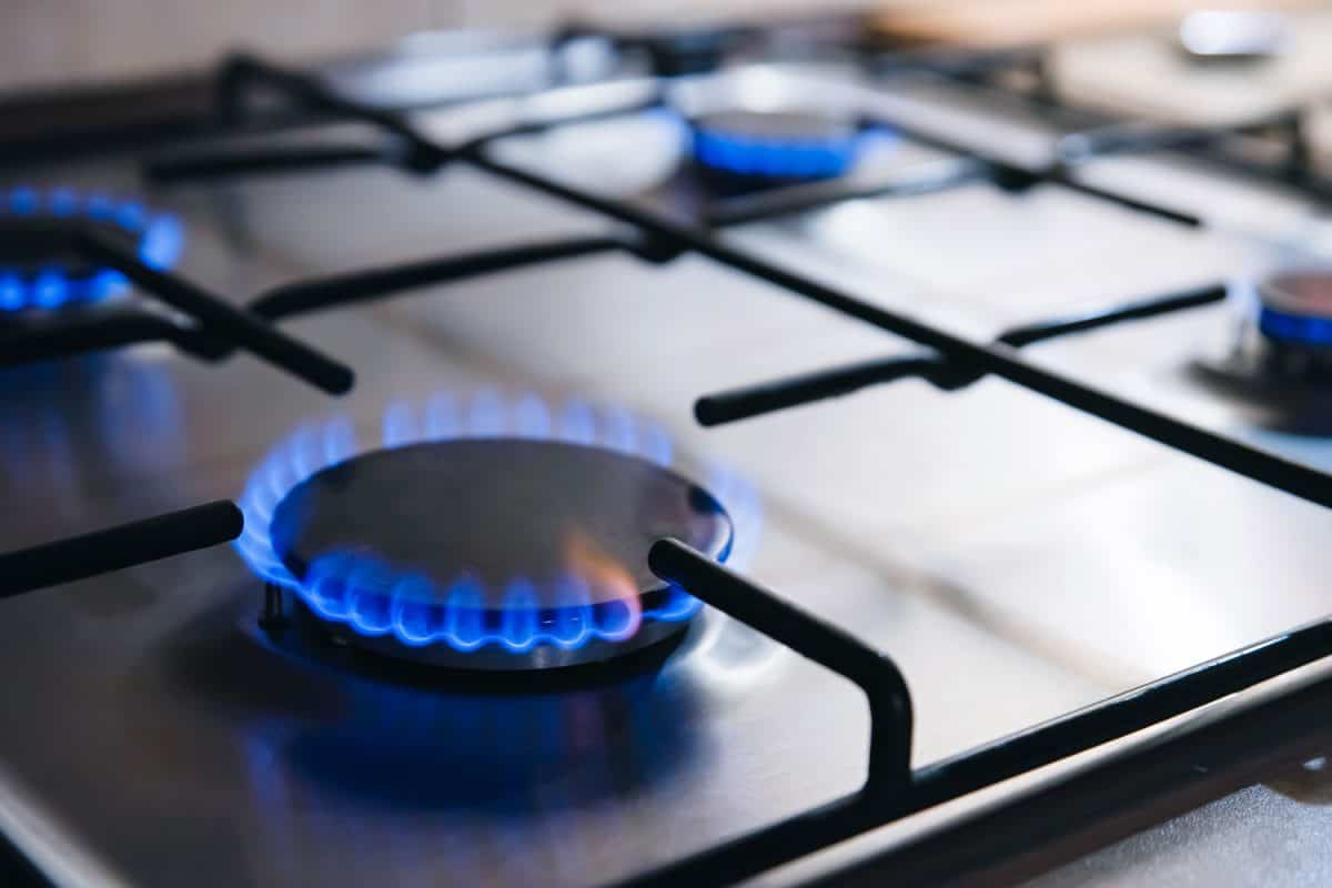 Up close photo of the blue flame of a gas stove