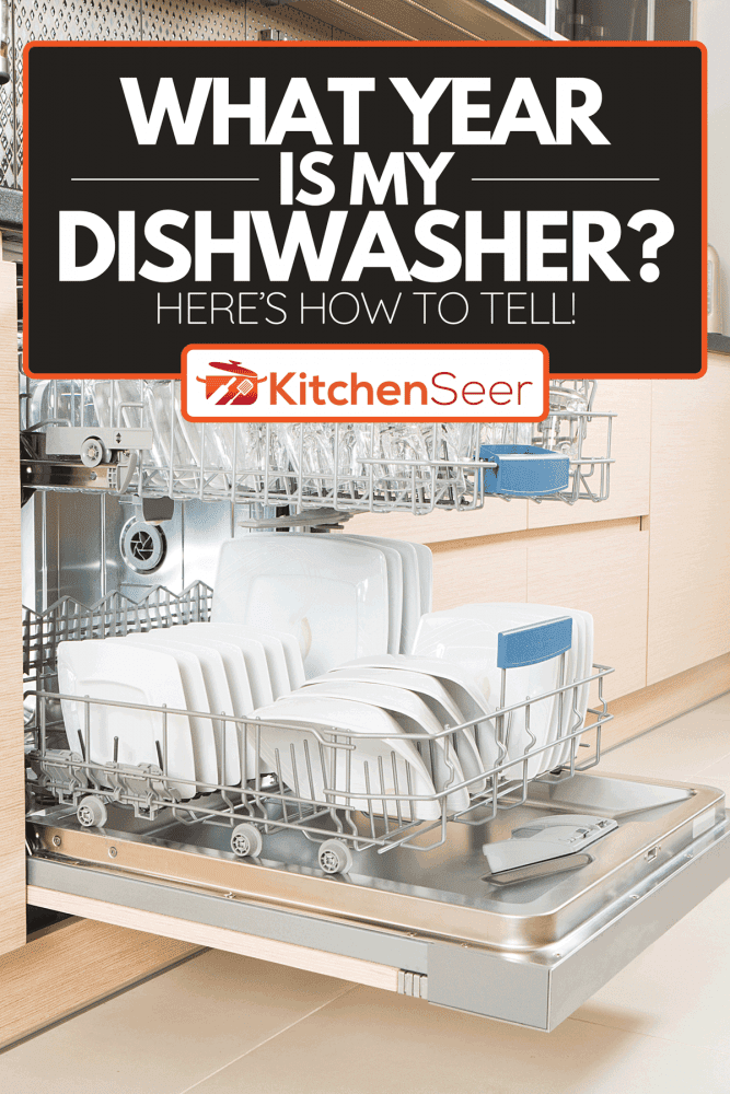 An open dishwasher with clean utensils in it, What Year Is My Dishwasher? Here’s How to Tell!