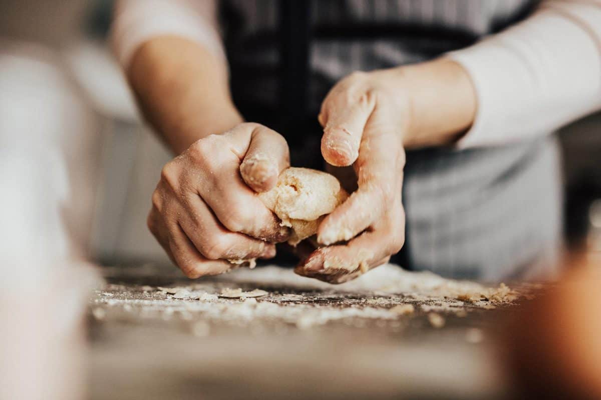 Woman's hands kneading dough