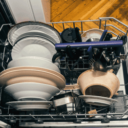 clean dishes and utensils on a open dishwasher. Bosch Dishwasher Cycles Explained—Primary And Secondary Add-Ons