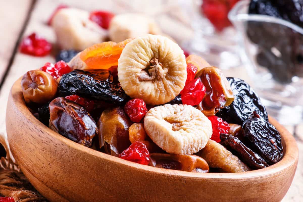 A bowl of dried raisins, grapes and other classes of fruits, Should You Soak Dried Fruit Before Baking?