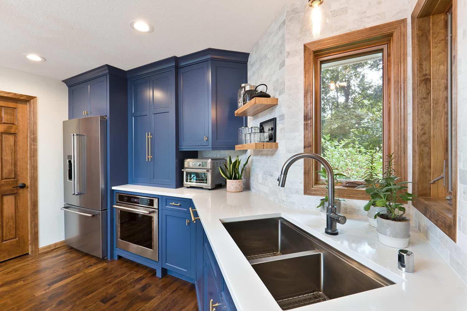 A contemporary kitchen renovation remodeling featuring a hardwood floor kitchen sink