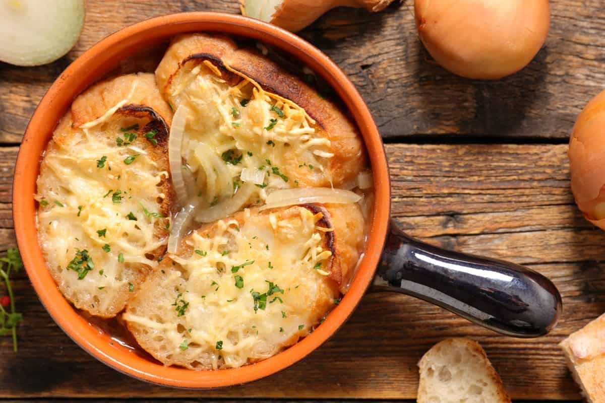A delicious baked onion soup with French bread on the table