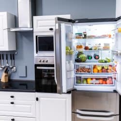 A double door fridge containing fruits, vegetables and wines placed in the corner of the kitchen, Can You Place A Refrigerator In The Corner Of The Kitchen?