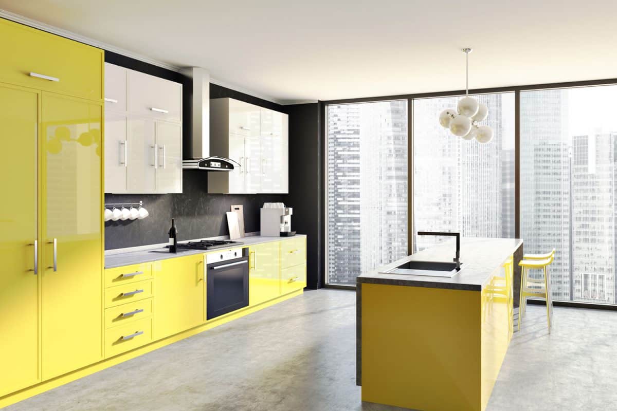 A retro themed condominium apartment with yellow cabinetries and gray countertop