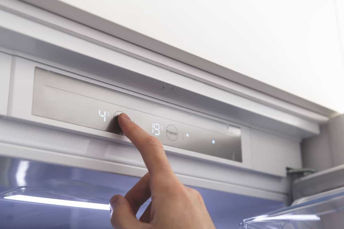 A woman adjusting the temperature of the refrigerator, How To Adjust Temperature On Danby Refrigerator