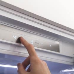 A woman adjusting the temperature of the refrigerator, How To Adjust Temperature On Danby Refrigerator