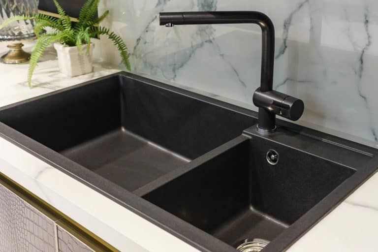 A black kitchen sink and tap water in the kitchen, 10 Types Of Kitchen Sinks