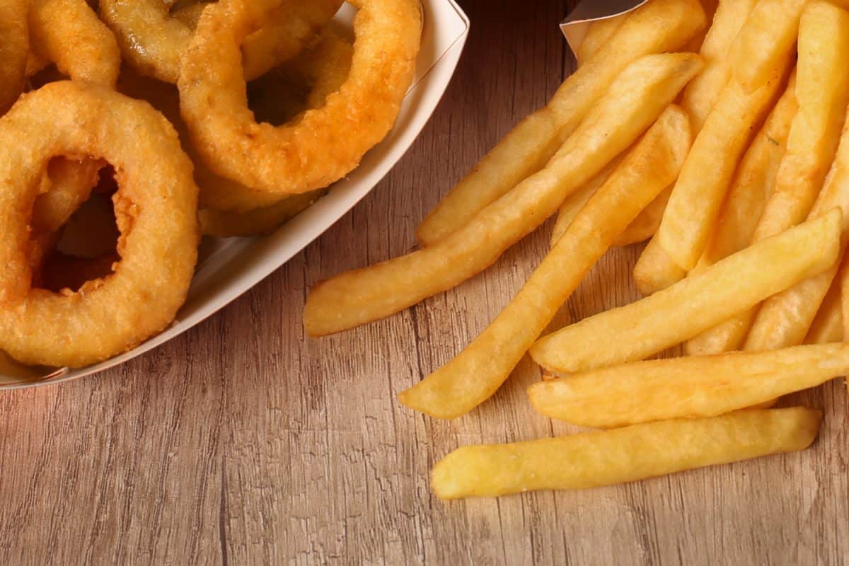 Close-up of fast food - Onion rings and french fries.