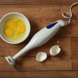 Cracked eggs next to an Immersion blender, How To Use A Cuisinart Immersion Blender