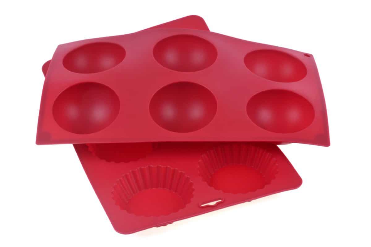 Dark red silicone muffin mold on a white background
