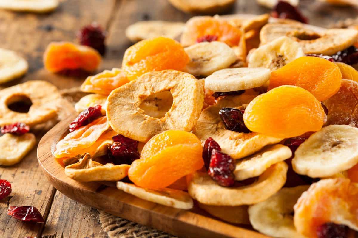 Delicious dried fruit on a wooden plate