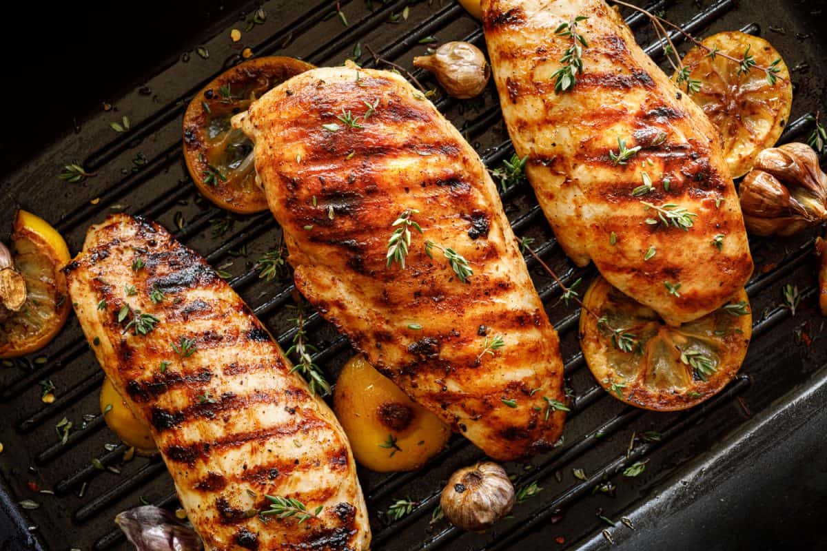 Delicious grilled chicken breast garnished with chives and oregano