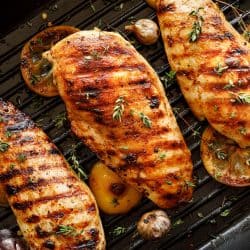 Delicious grilled chicken breast garnished with chives and oregano, How Long To Cook Chicken On Cuisinart Grill?