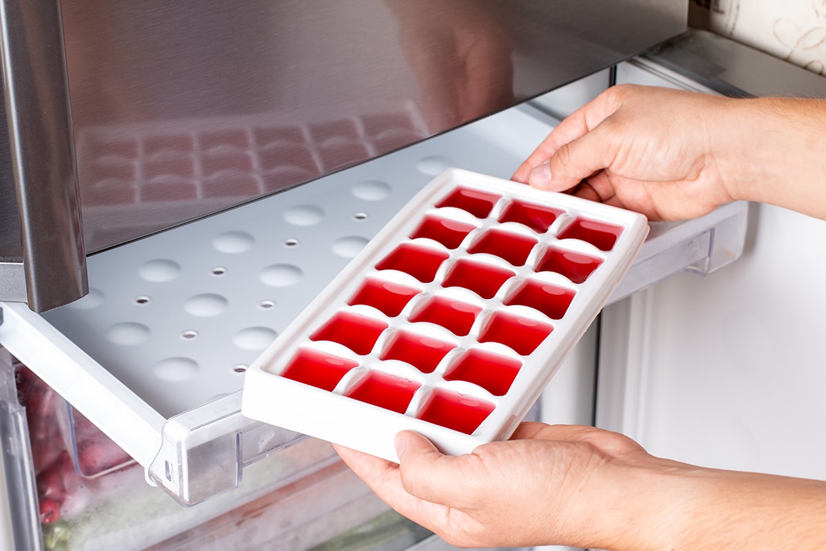 Ice cube tray with frozen wine in the freezer