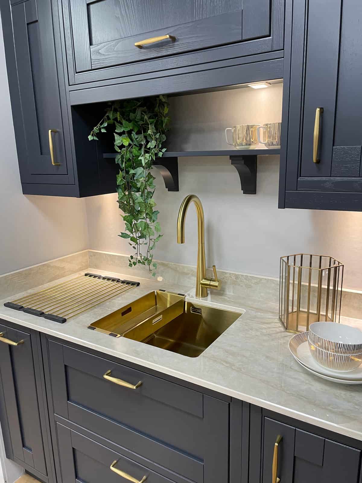 Image of modern kitchen with navy, wood grain effect wall and floor cabinets
