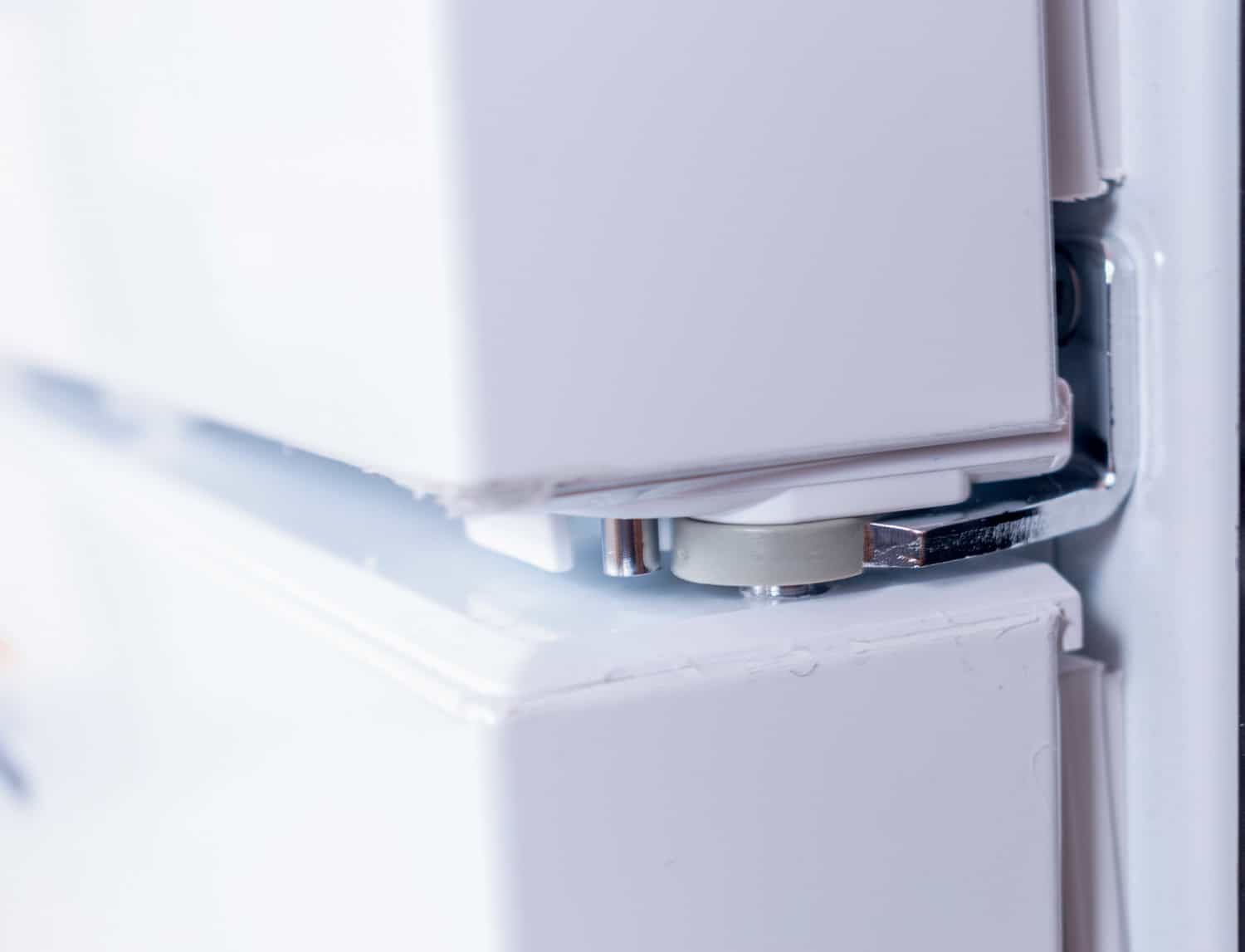 Metal hinge of a white color Refrigerator door