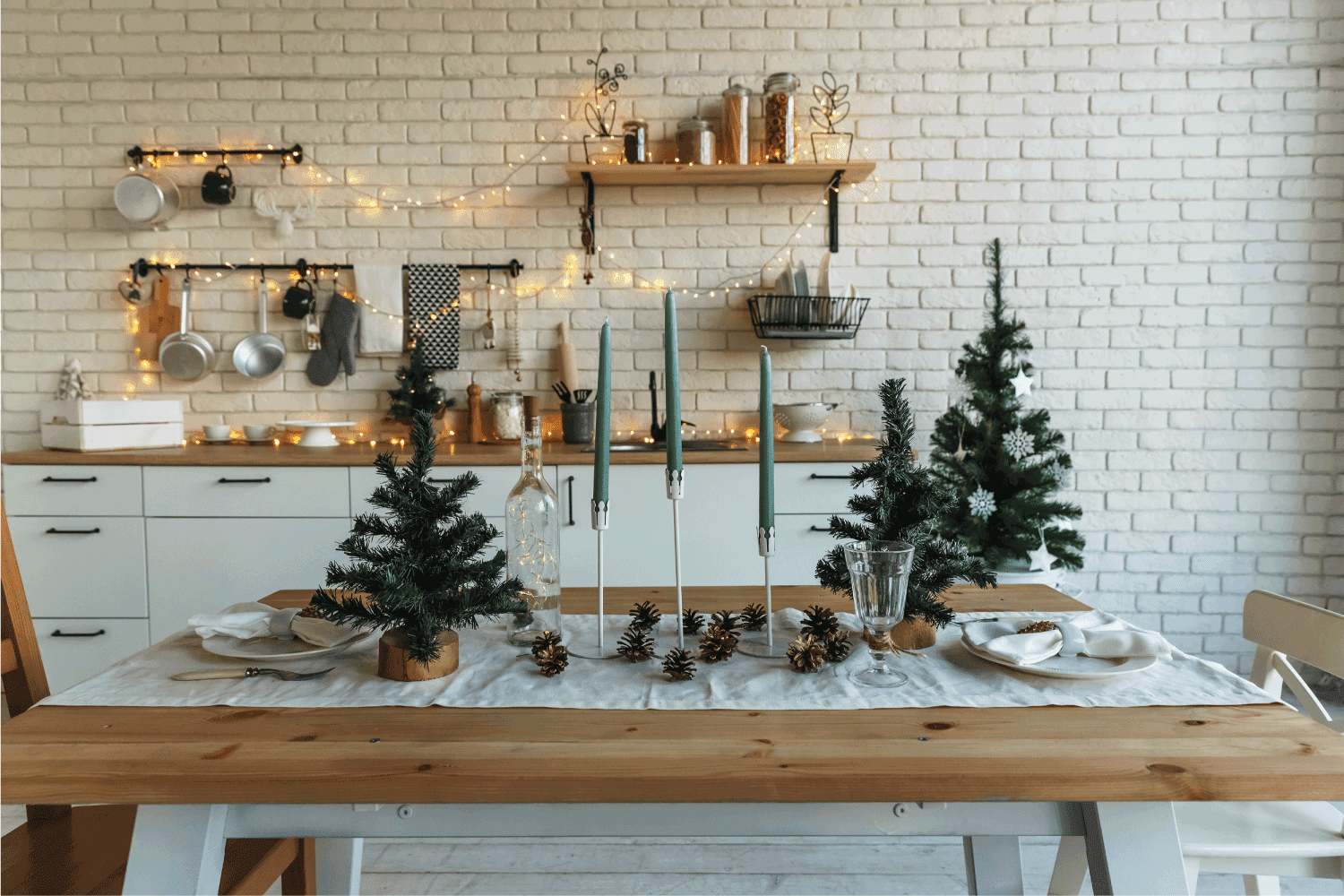 New Year and Christmas. Festive kitchen in Christmas decorations. Candles, spruce branches, wooden stands, table laying