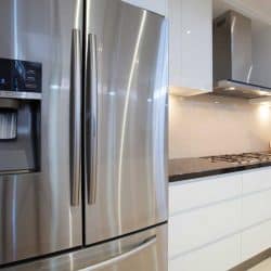 New luxurious kitchen interior with modern refrigerator, Why Does My Whirlpool Refrigerator Leak Water?
