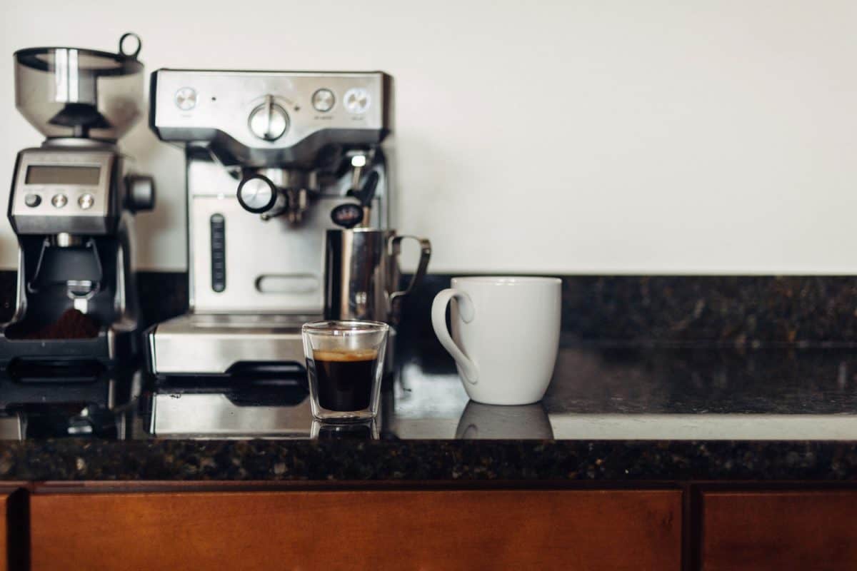 One shot of an Espresso and a Breville Espresso machine on the countertop