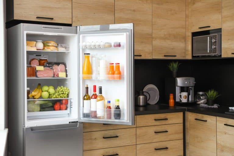 Open refrigerator full of products in kitchen, Do Whirlpool Refrigerators Require A Stabilizer?