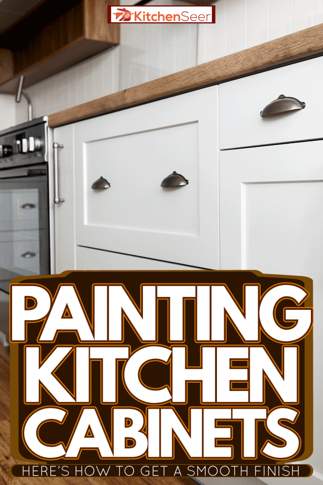 White cabinets with stainless steel handle bars inside a rustic themed kitchen, Painting Kitchen Cabinets - Here's How To Get A Smooth Finish