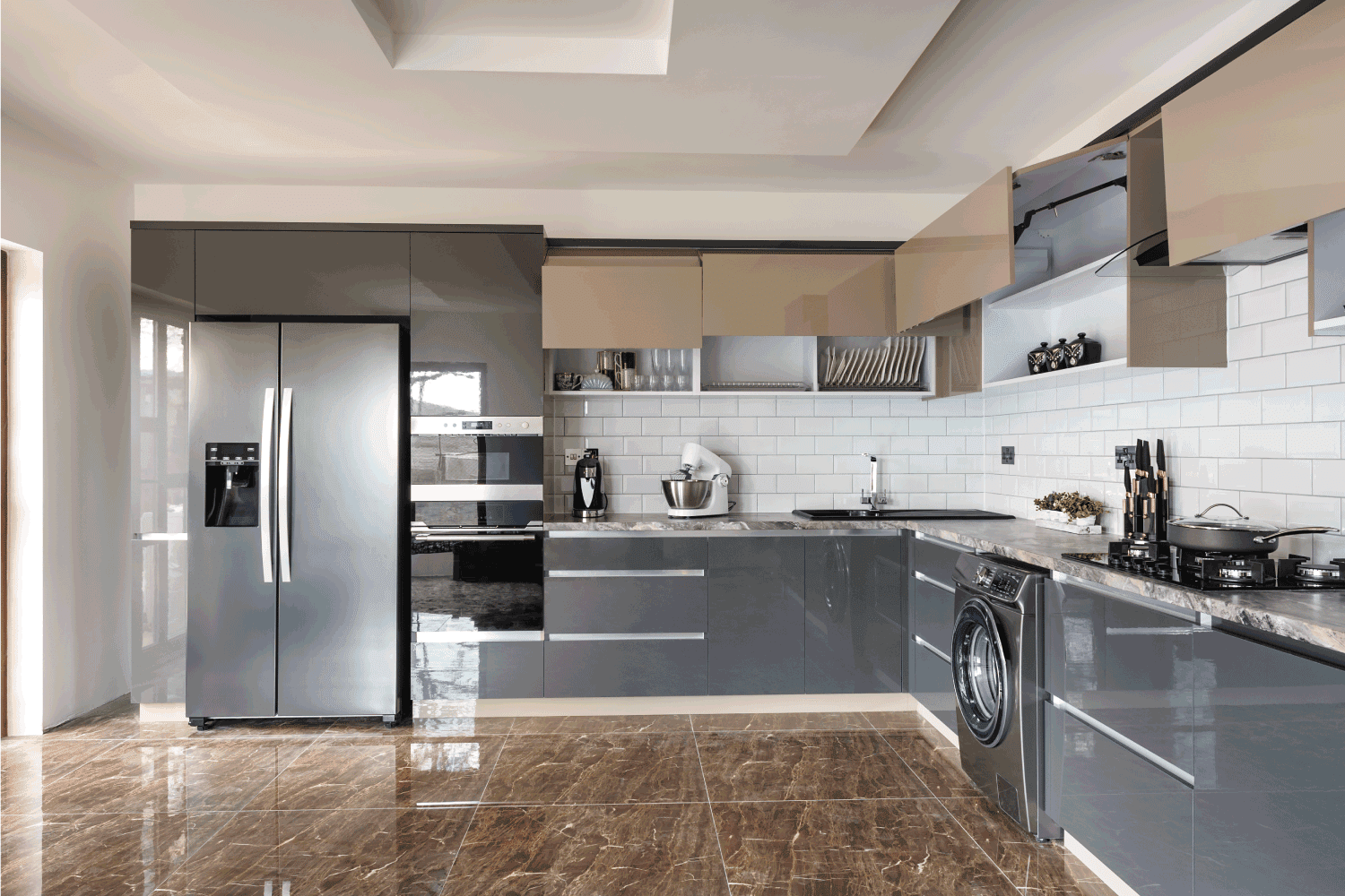 Spacious luxury well designed modern grey, beige and white kitchen with marble tiles floor and high end refrigerator