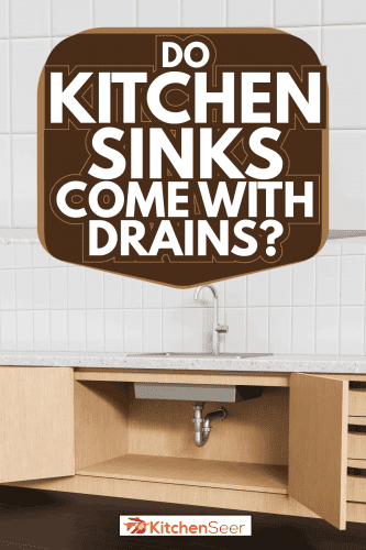 Stainless steel water pipes under sink, kitchen cabinets with open doors. Do Kitchen Sinks Comes With Drains