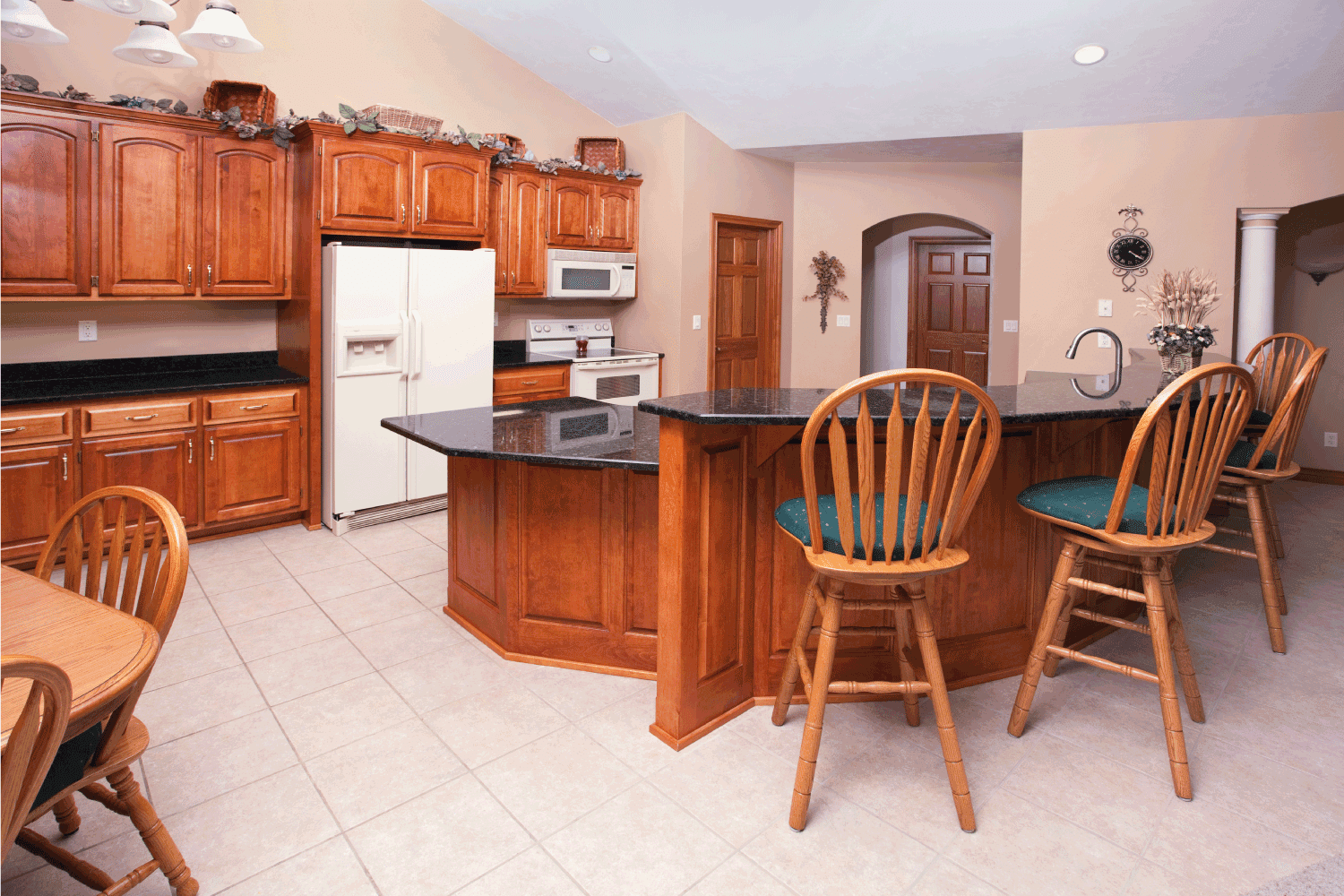  casual eat-in kitchen has a granite half-circle counter and plenty of open space for a family to dine-in