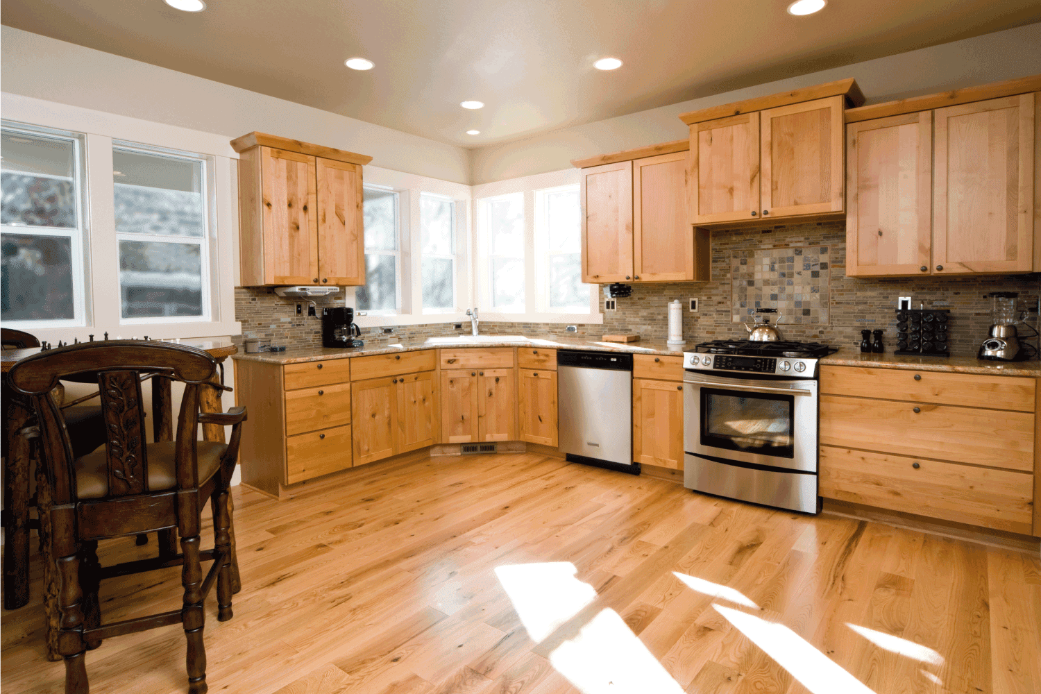 modern kitchen, has knotted alder cabinets, brick details on the walls and back splash. The hardwood floors complete the beauty of this kitchen.