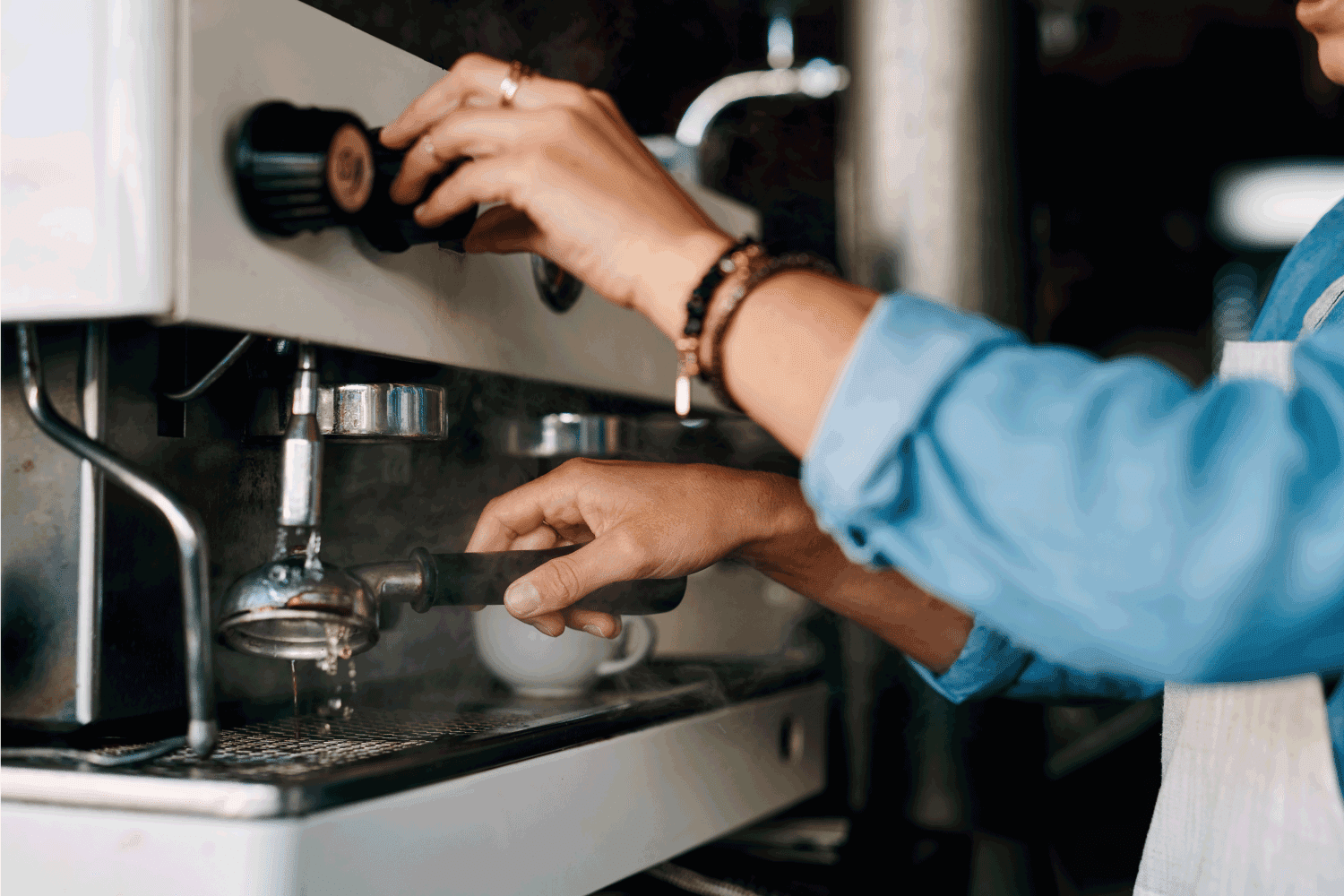 woman operating espresso machine, cleaning espresso machine using hot water