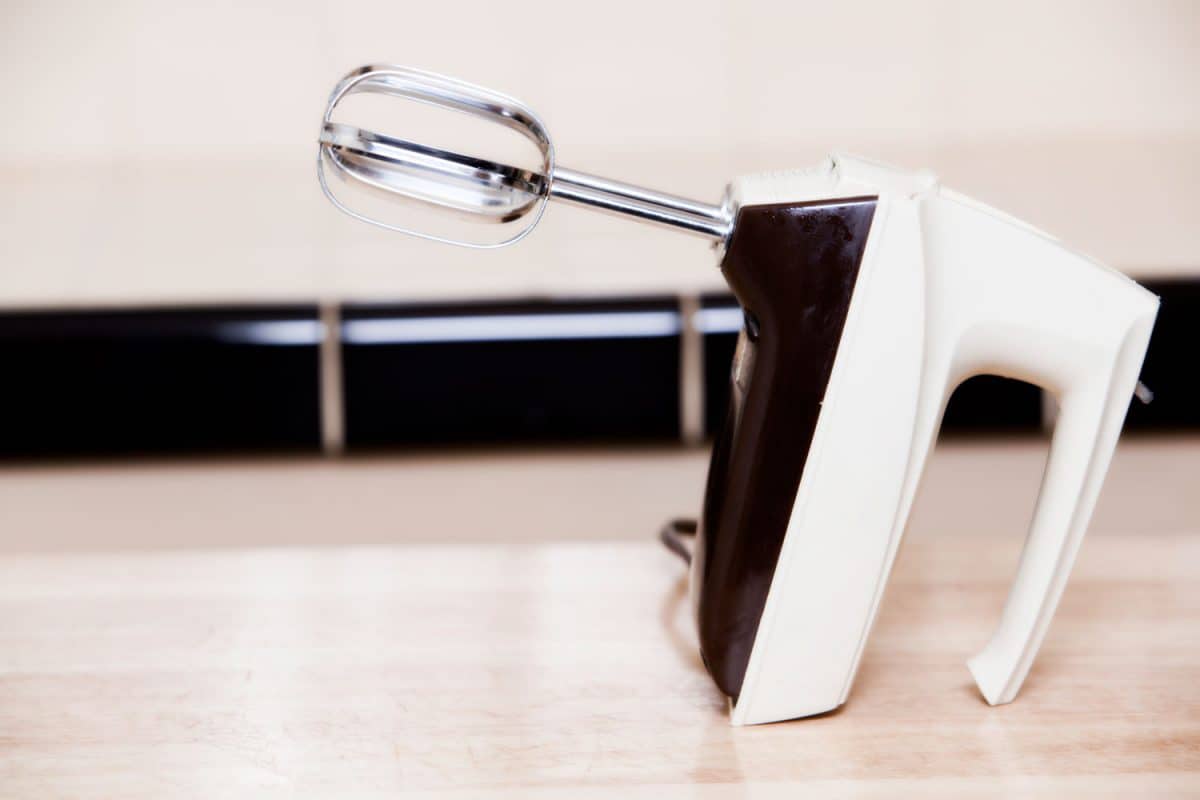 A black and white hand mixer on the countertop