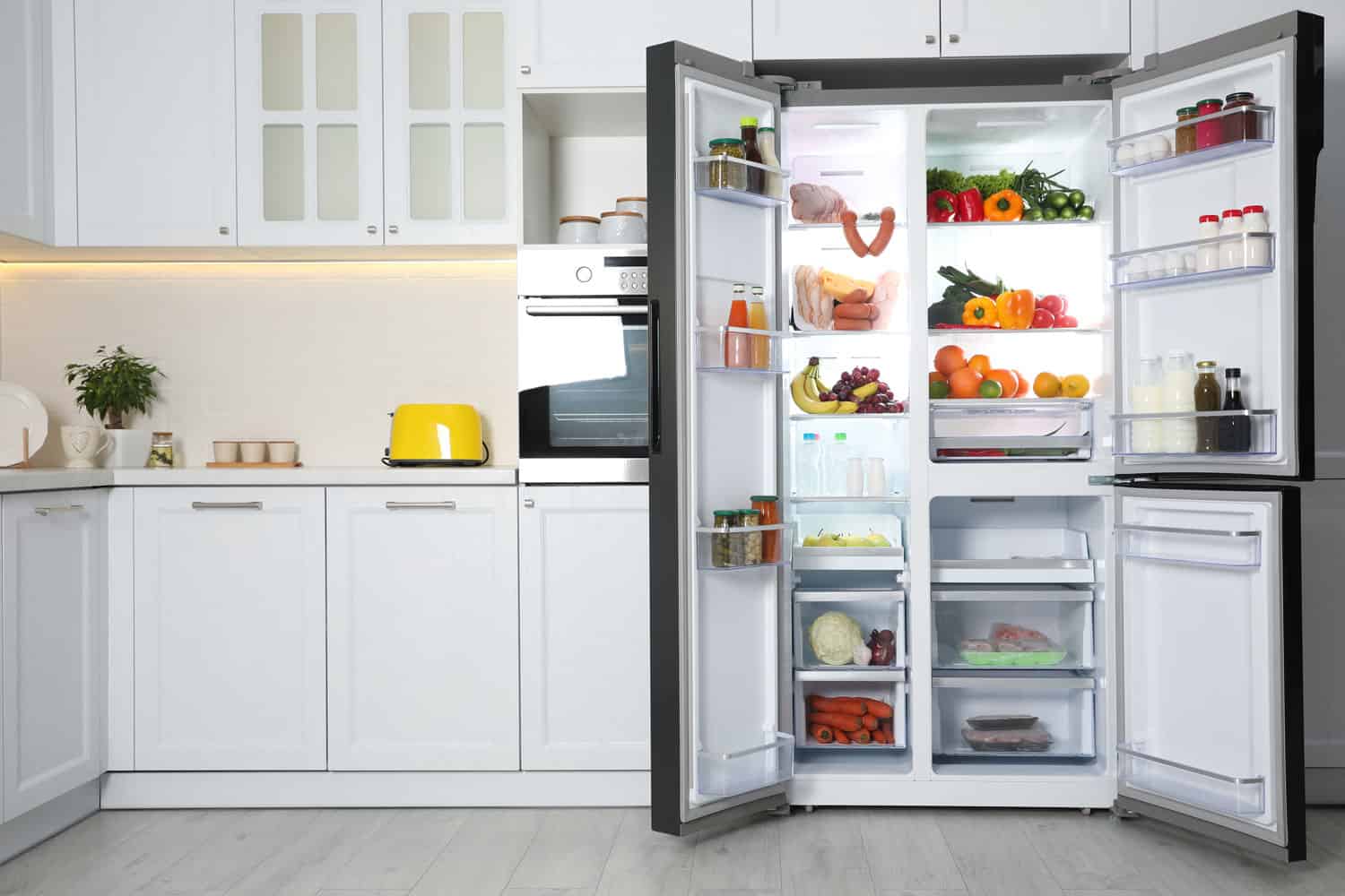 An opened double door fridge with lots of essential necessities, How Old Is My Refrigerator? Here's How To Find Out!