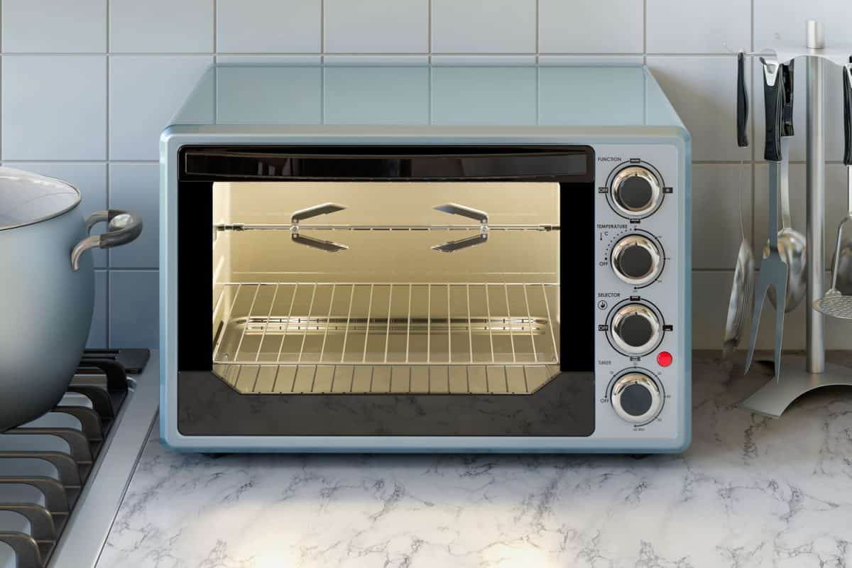 A small light blue colored oven on the kitchen countertop