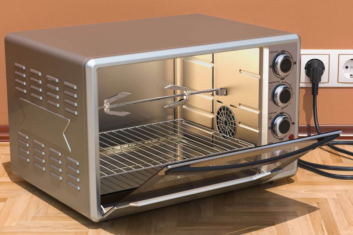 A small silver colored oven with a rotisserie
